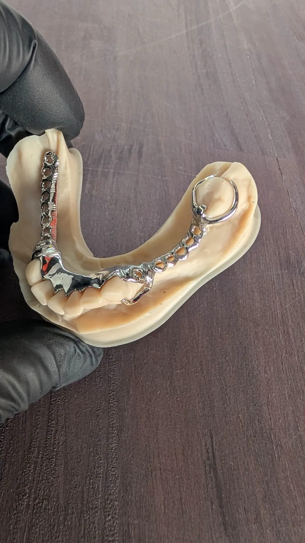 Polished lower cobalt-chrome partial denture framework on a model