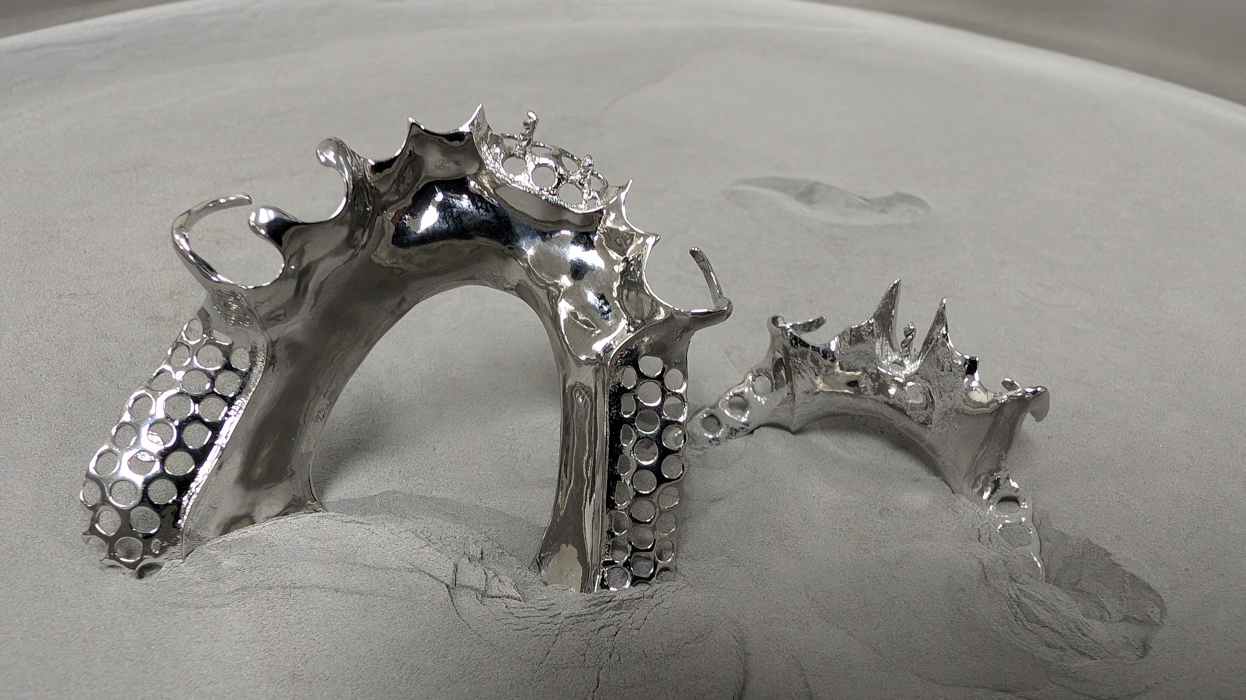 Polished chrome framework on gray surface, dramatic angle