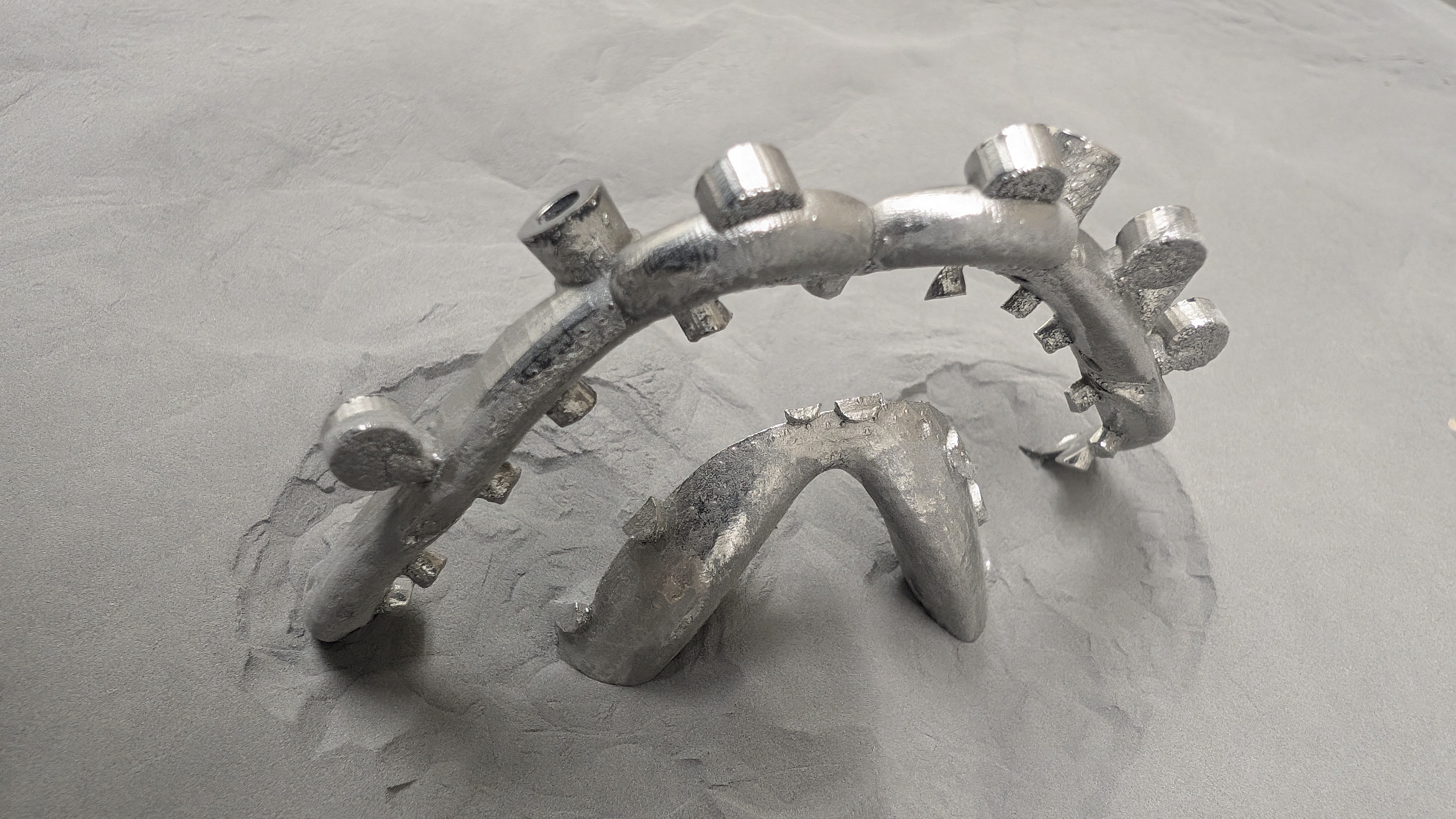 Chrome framework with mesh retention held in tweezers