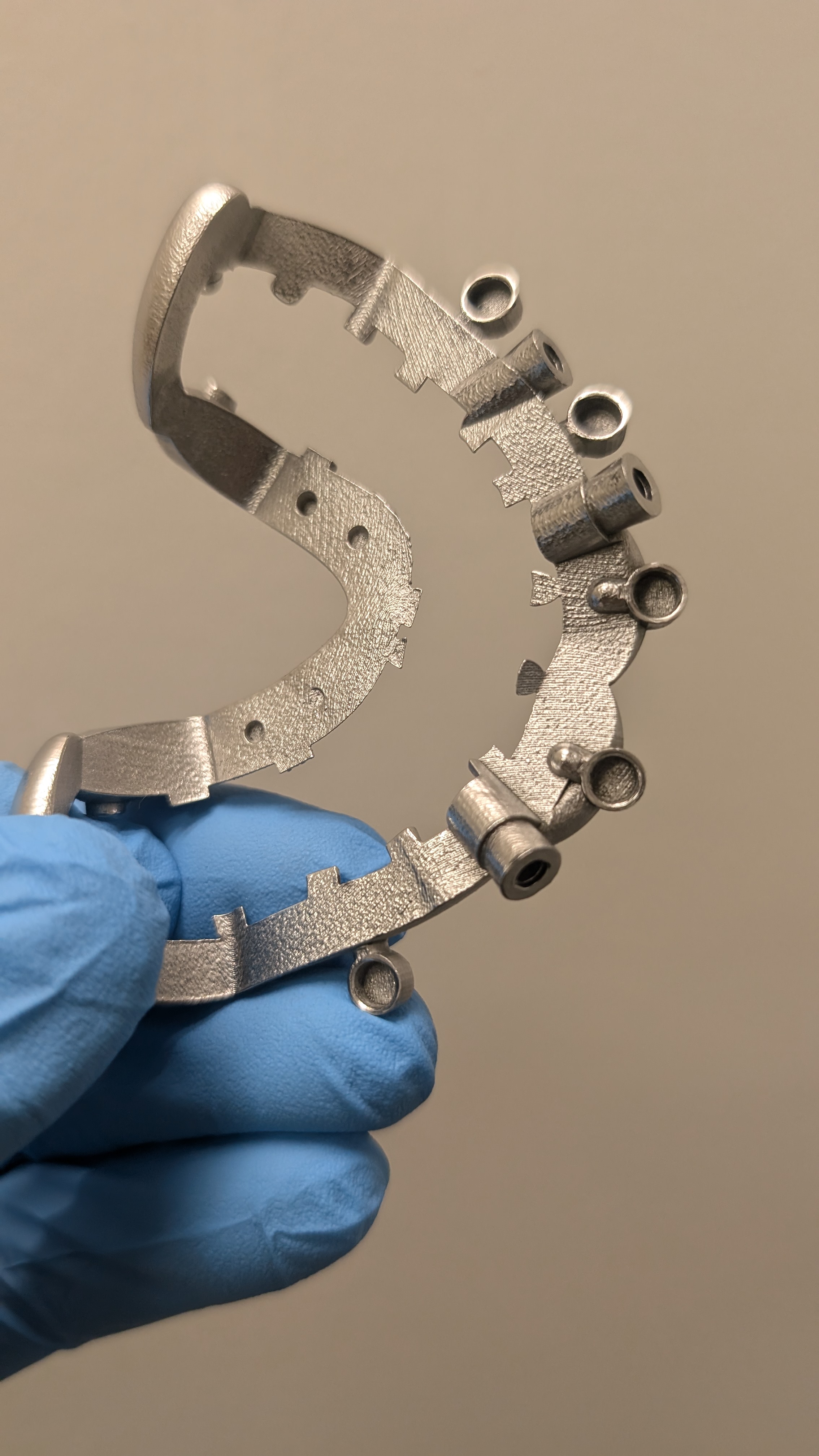 Raw 3D printed framework with support structures in blue glove