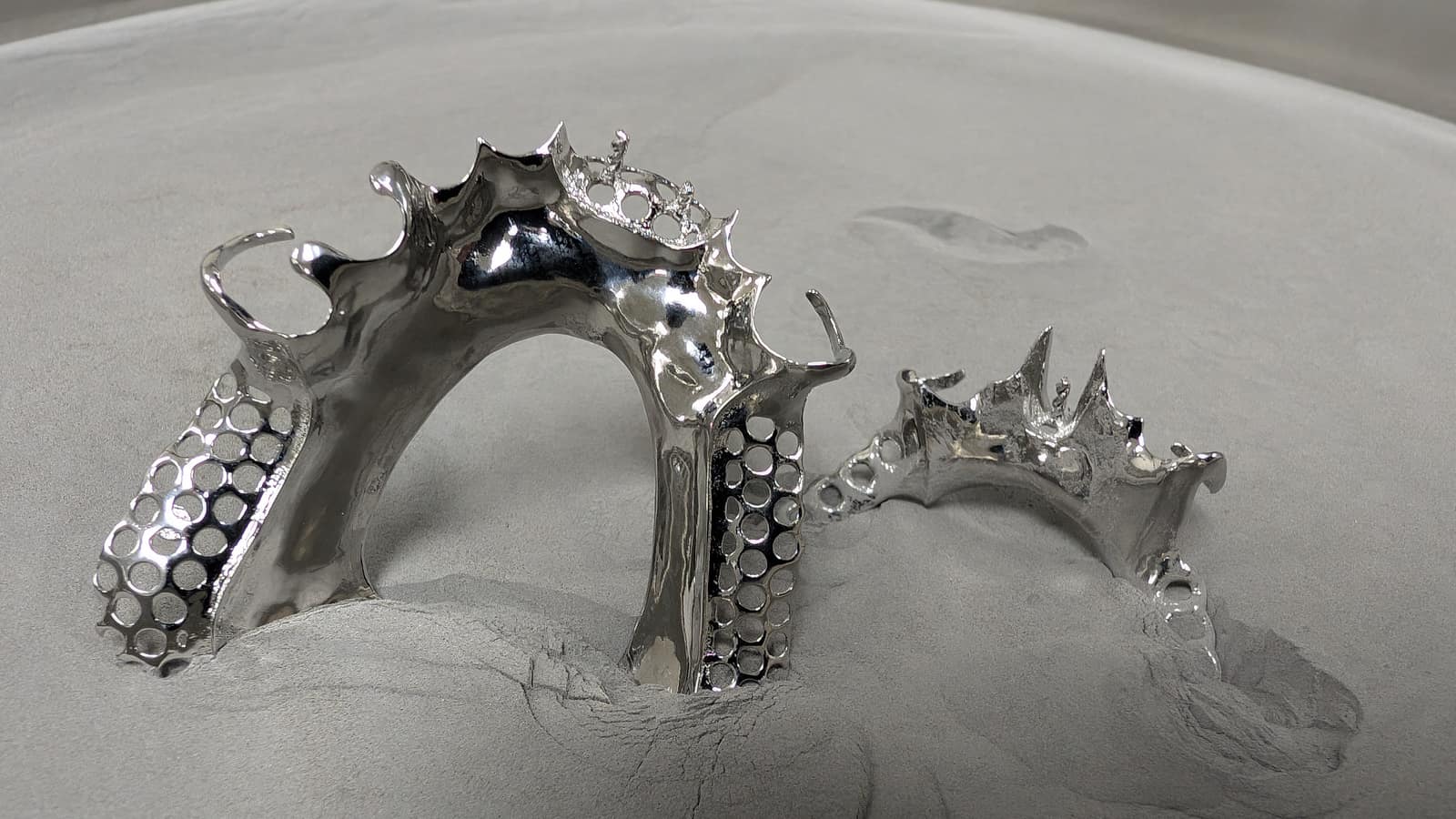 Two mirror-polished cobalt-chrome partial frameworks completed by True North Kromes